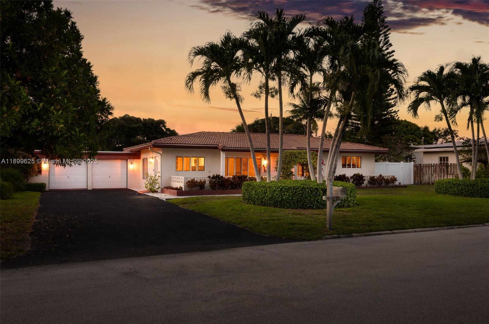 435 Northeast 36th Street Boca Raton, FL 33431 - Photo 1 of 25 a front view of a house with a garden and trees