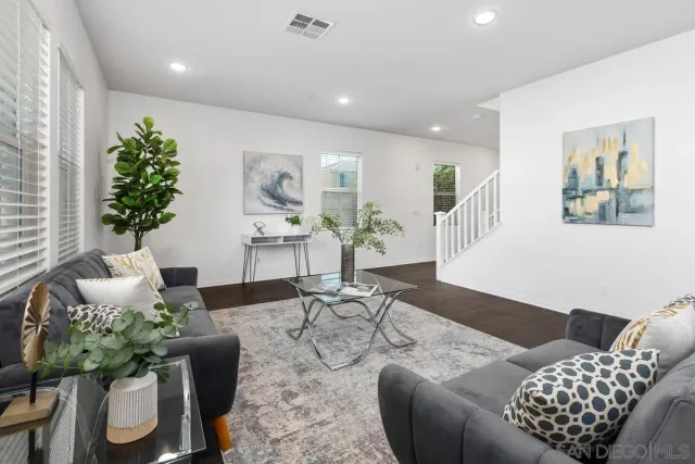 a living room with furniture and flowers