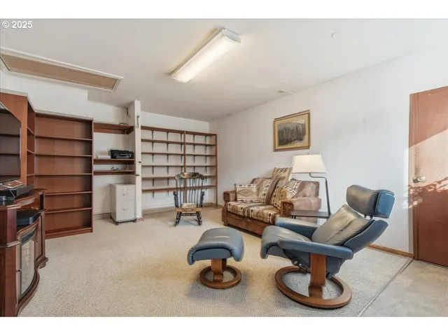 a living room with furniture a air conditioner and a window