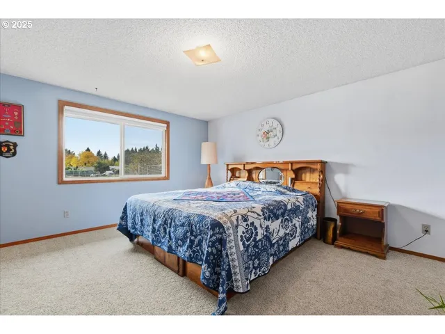 a bed sitting in a bedroom next to a window