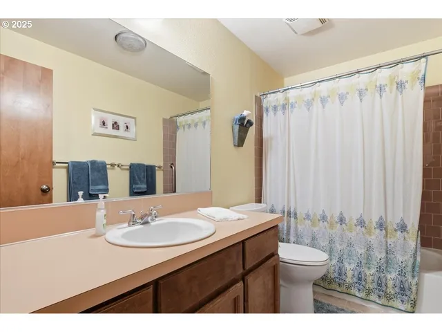 a bathroom with a sink toilet a mirror and shower