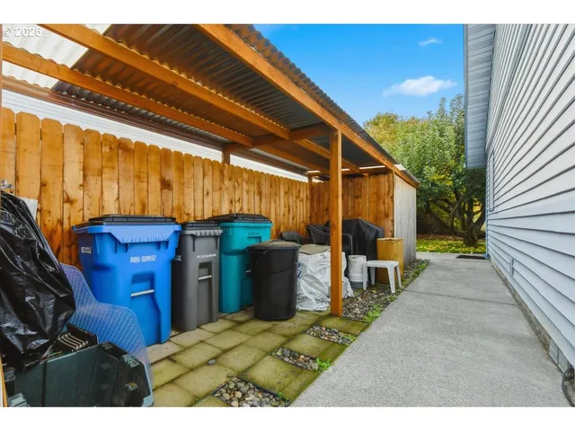 a view of a backyard with table and chairs