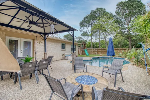 a swimming pool with a outdoor seating and plants