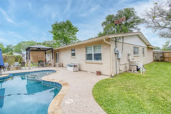 a view of a backyard with swimming pool