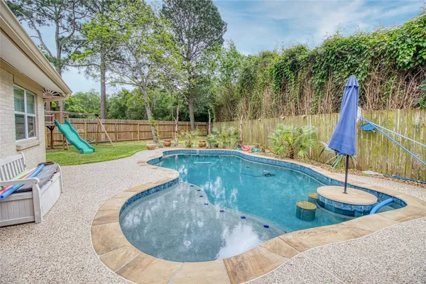 a view of a house with a yard patio and fire pit