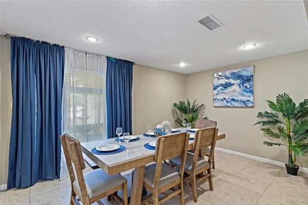 a view of a dining room with furniture and window