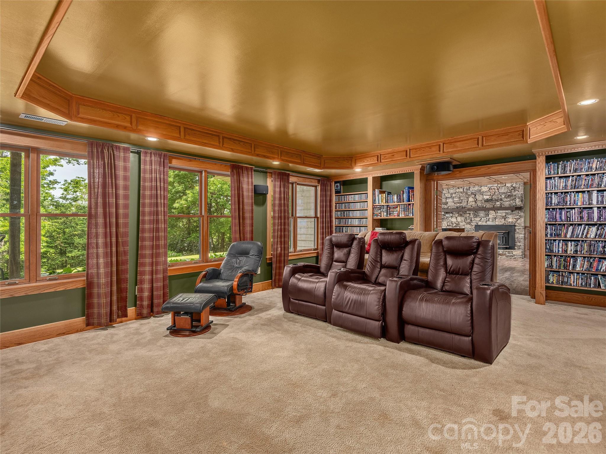 40 Deer Ridge Road Mills River, NC 28759 - Photo 17 of 35 a living room with furniture a flat screen tv and floor to ceiling window