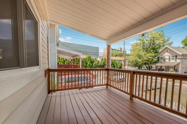 a view of balcony with wooden floor
