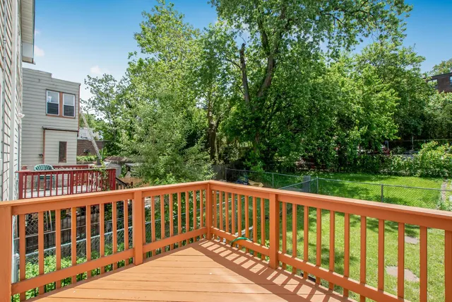 a view of a wooden deck with large trees