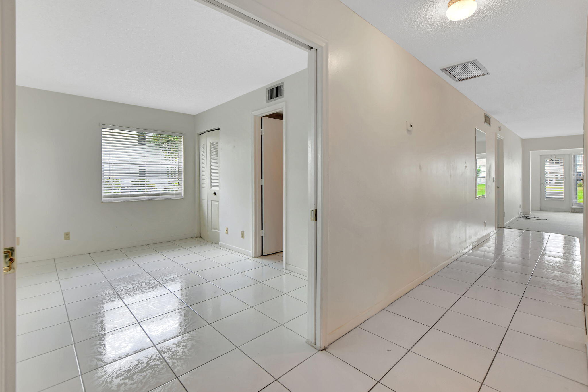 2830 Southwest 13th Street, Unit 101 Delray Beach, FL 33445 - Photo 10 of 56 Hallway & Second Bedroom