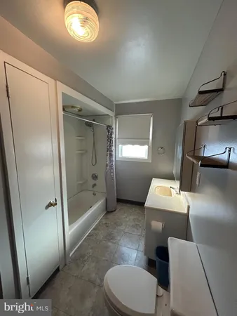 a bathroom with a toilet a sink and a mirror