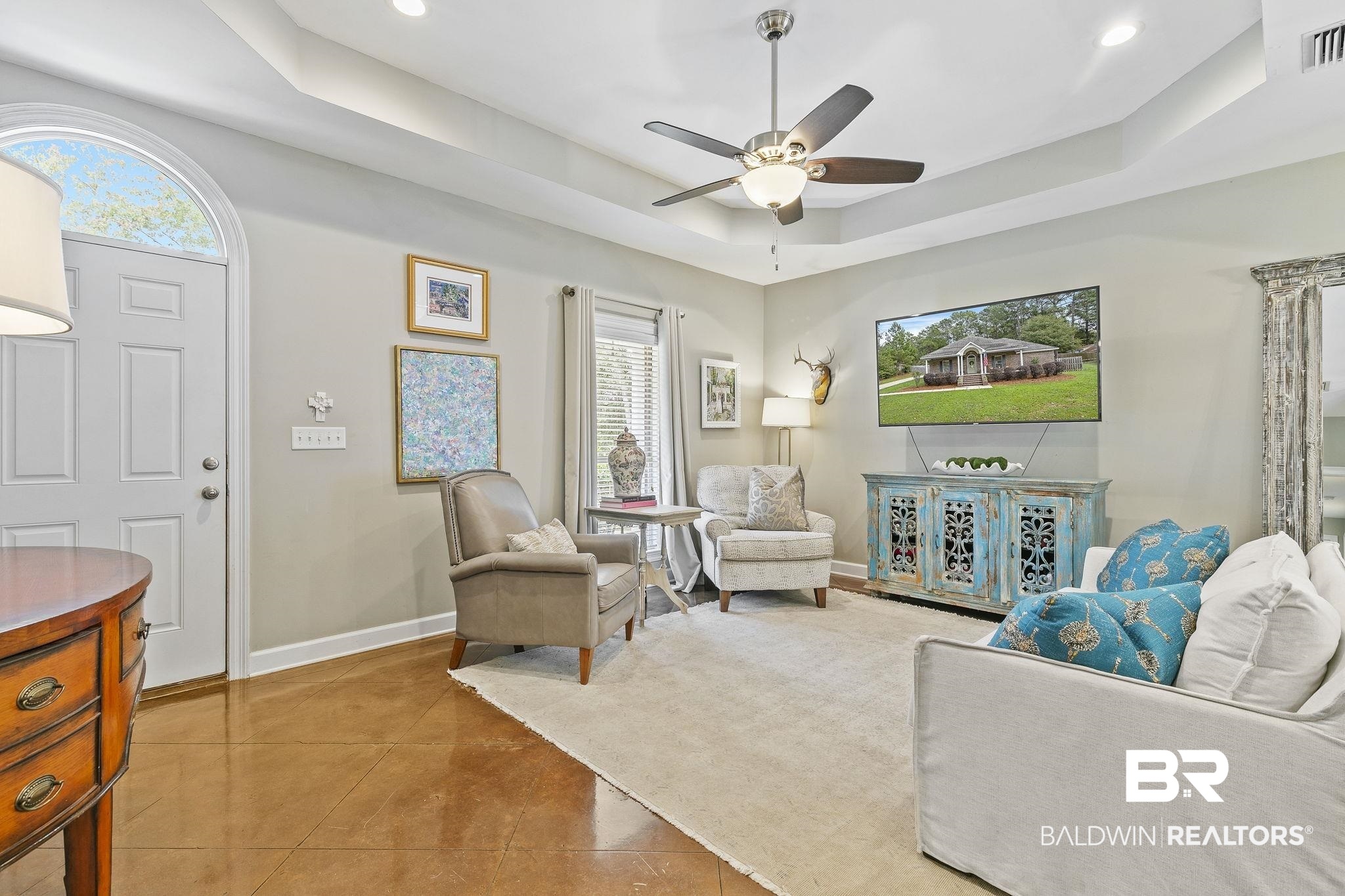 32072 Buzbee Road Daphne, AL 36527 - Photo 9 of 41 Living room with tile patterned flooring, ceiling fan, and a tray ceiling