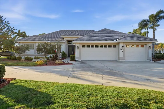 a front view of a house with a yard and a garage