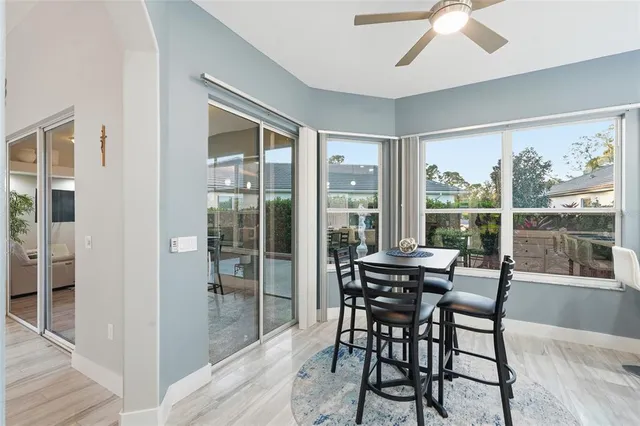 a kitchen with granite countertop a sink stainless steel appliances and white cabinets