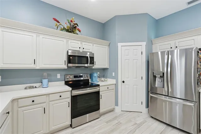 a view of a workspace with furniture and wooden floor