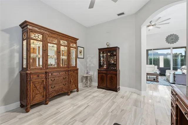 a spacious bedroom with a bed and a chandelier
