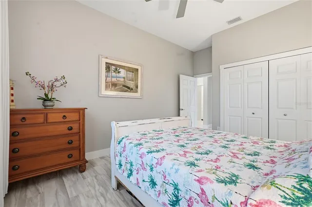 a bedroom with a bed and a potted plant