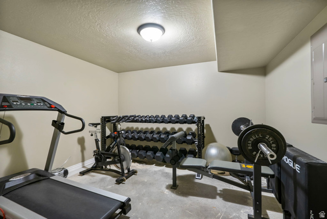 557 South 1470th Street East Springville, UT 84663 - Photo 29 of 46 Exercise room with a textured ceiling, concrete flooring, and electric panel