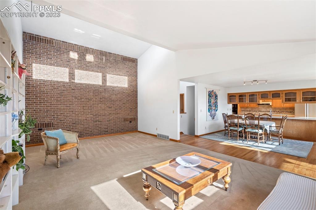 1711 Columbine Road Colorado Springs, CO 80907 - Photo 11 of 50 a living room with furniture a rug and a large window