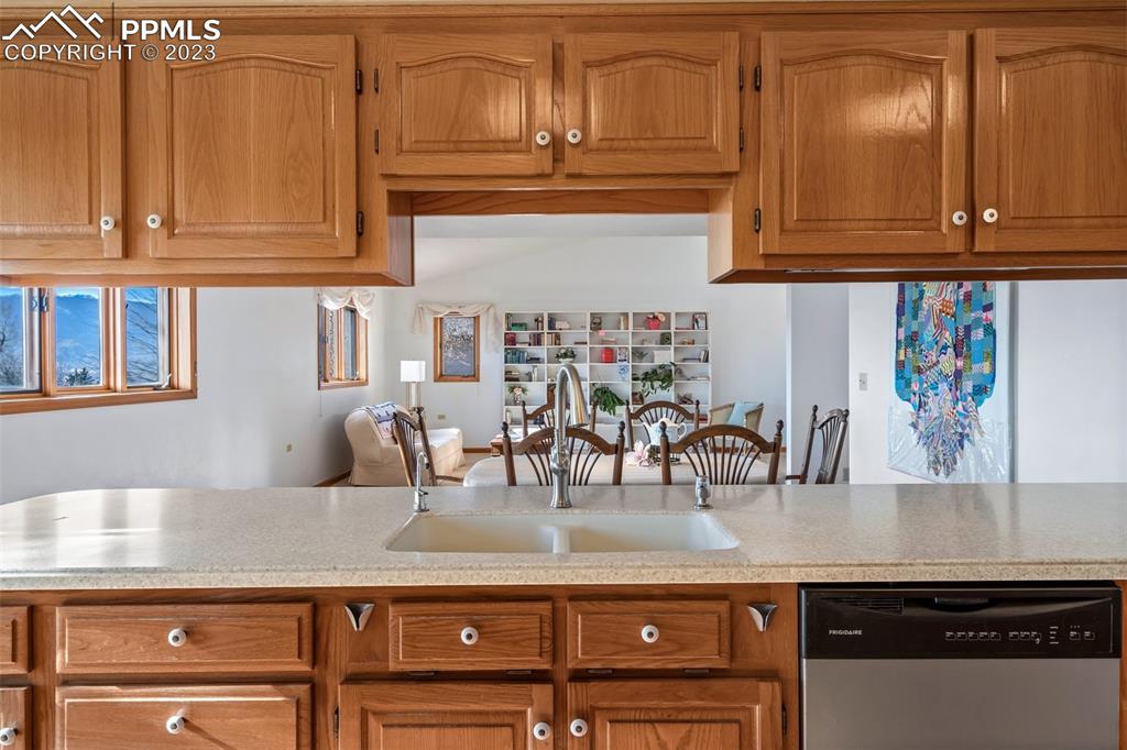 1711 Columbine Road Colorado Springs, CO 80907 - Photo 14 of 50 a kitchen with granite countertop a sink and cabinets