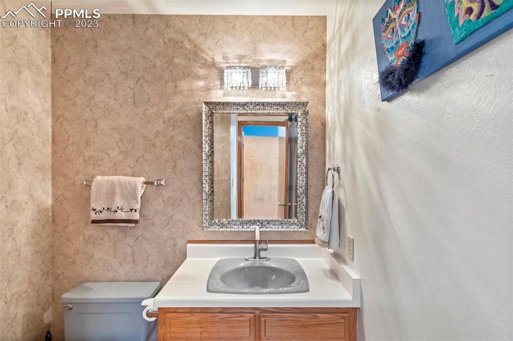 1711 Columbine Road Colorado Springs, CO 80907 - Photo 16 of 50 a bathroom with a sink and a mirror