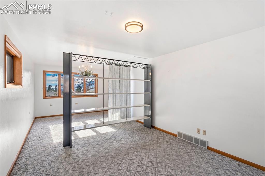1711 Columbine Road Colorado Springs, CO 80907 - Photo 18 of 50 a view of empty room with wooden floor