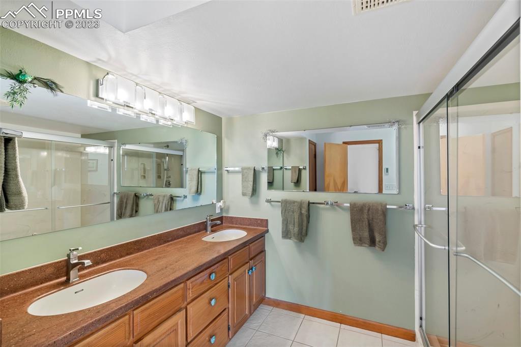 1711 Columbine Road Colorado Springs, CO 80907 - Photo 22 of 50 a bathroom with a double vanity sink mirror and double