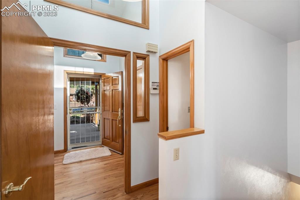 1711 Columbine Road Colorado Springs, CO 80907 - Photo 3 of 50 a view of a hallway with wooden floor and a living room
