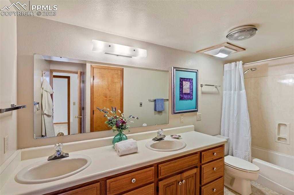 1711 Columbine Road Colorado Springs, CO 80907 - Photo 31 of 50 a bathroom with a sink and a mirror