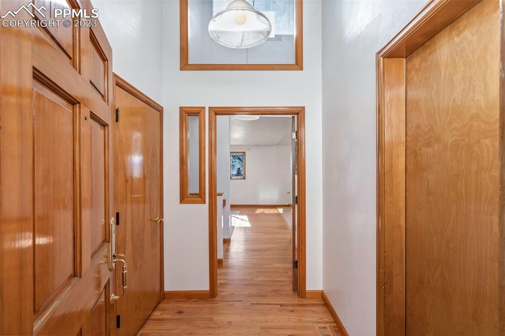 1711 Columbine Road Colorado Springs, CO 80907 - Photo 4 of 50 a view of a hallway with wooden floor and closet