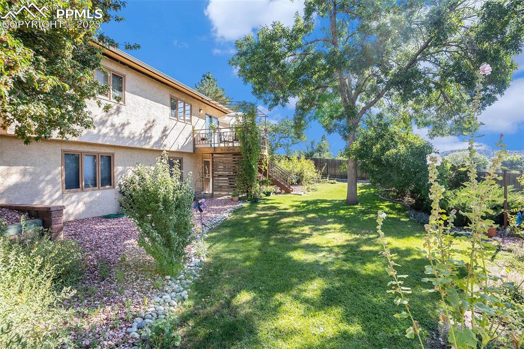 1711 Columbine Road Colorado Springs, CO 80907 - Photo 48 of 50 a backyard of a house with lots of green space