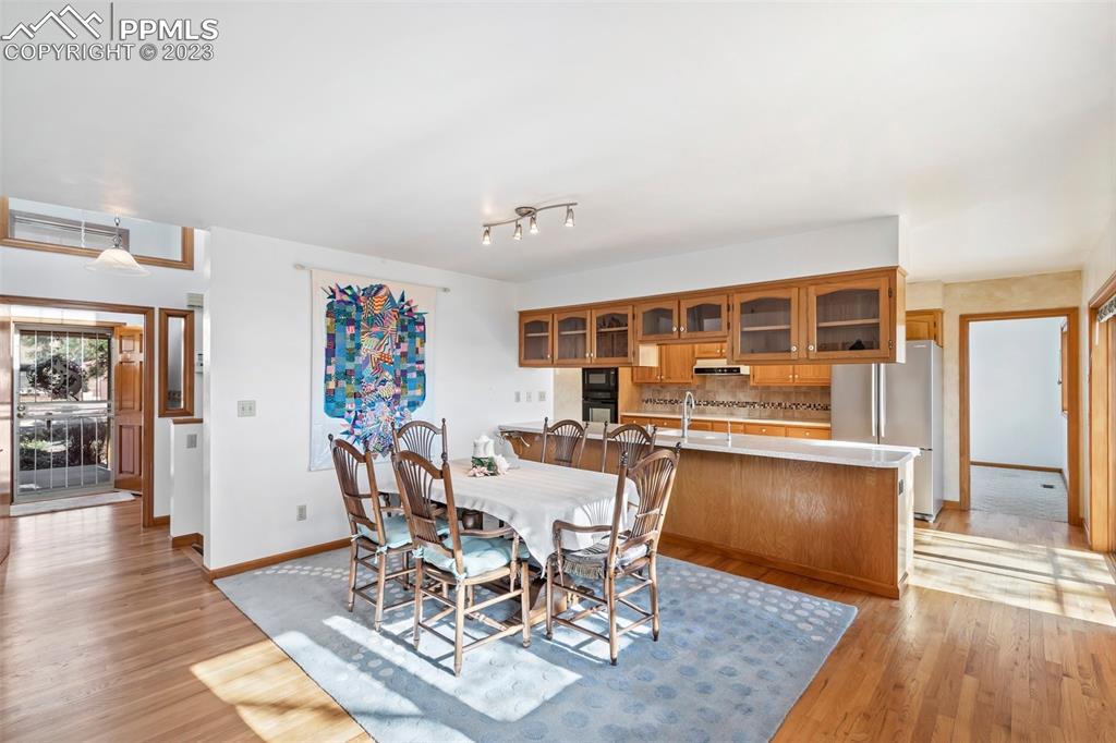 1711 Columbine Road Colorado Springs, CO 80907 - Photo 5 of 50 a dining room with wooden floor and large window