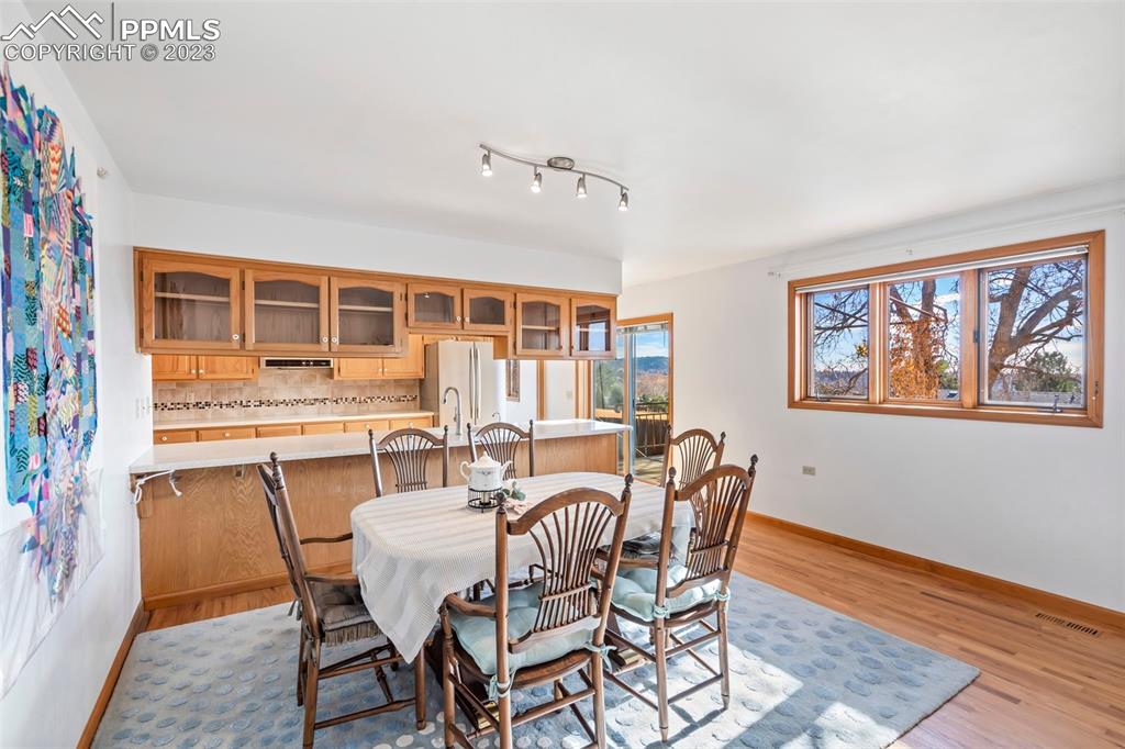 1711 Columbine Road Colorado Springs, CO 80907 - Photo 7 of 50 a dining room with furniture a window and wooden floor