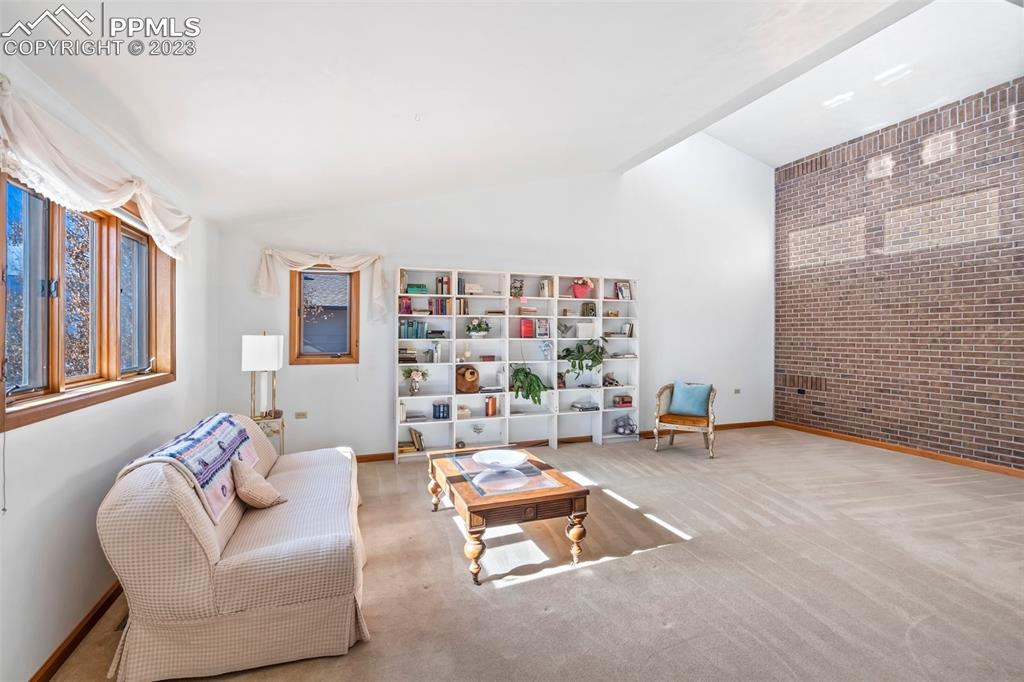 1711 Columbine Road Colorado Springs, CO 80907 - Photo 8 of 50 a living room with furniture and a book shelf