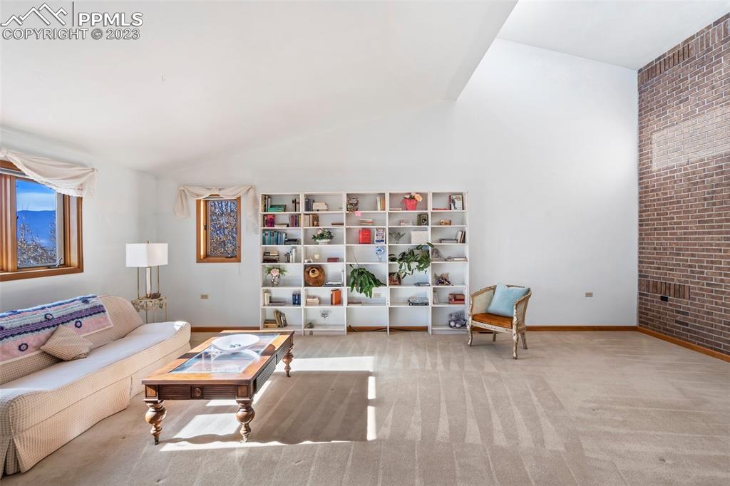 1711 Columbine Road Colorado Springs, CO 80907 - Photo 9 of 50 a bedroom with furniture and a book shelf