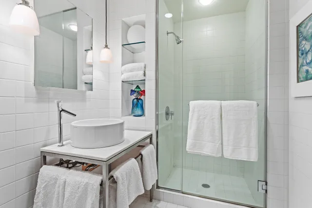 a living room with furniture a bookshelf and a window