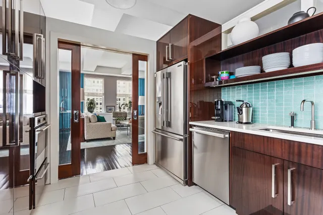 a kitchen with stainless steel appliances granite countertop a refrigerator and a sink