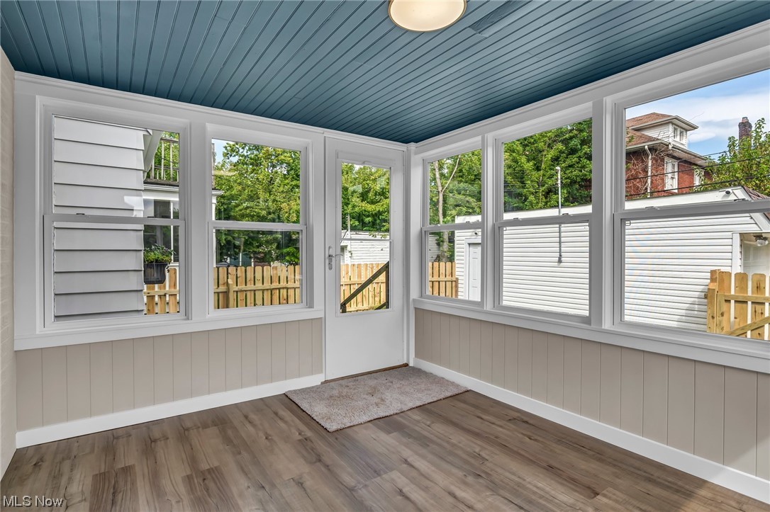 3669 Silsby Road University Heights, OH 44118 - Photo 11 of 34 Sunroom with brand new windows, LVT flooring, and framing. The old room was re-built