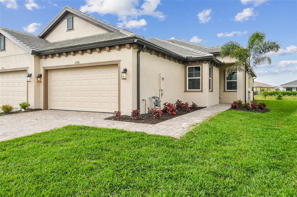 17982 Cherished Loop Lakewood Ranch, FL 34211 - Photo 1 of 1 a front view of a house with a yard and garage
