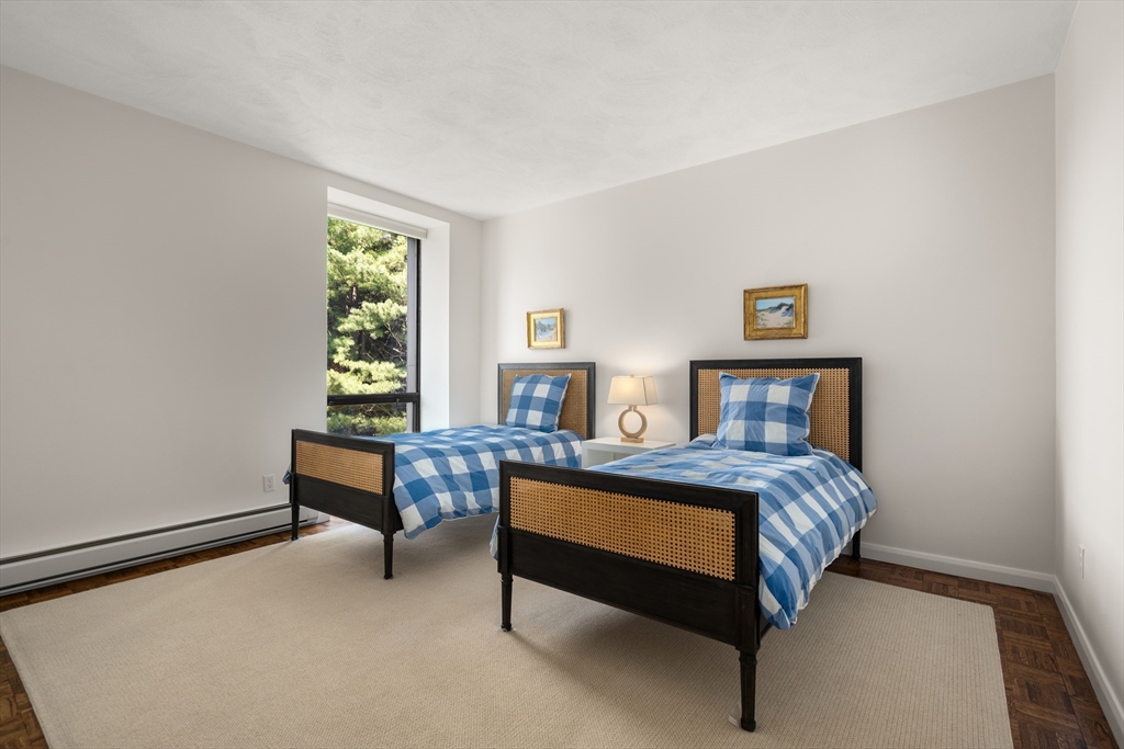 75 Grove Street, Unit 429 Wellesley, MA 02482 - Photo 11 of 22 a bedroom with a bed and a window