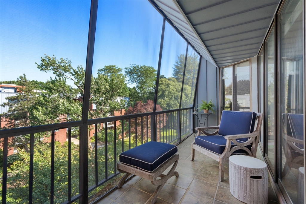75 Grove Street, Unit 429 Wellesley, MA 02482 - Photo 16 of 22 a view of a chair and table in the balcony
