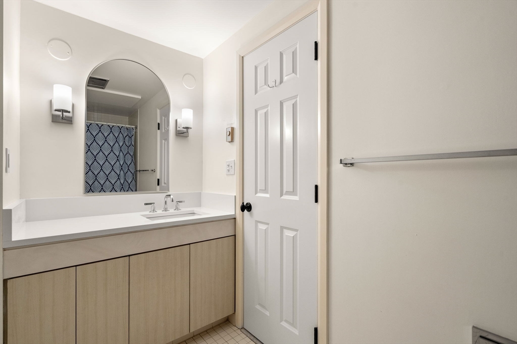 75 Grove Street, Unit 429 Wellesley, MA 02482 - Photo 10 of 22 a bathroom with a sink and a mirror