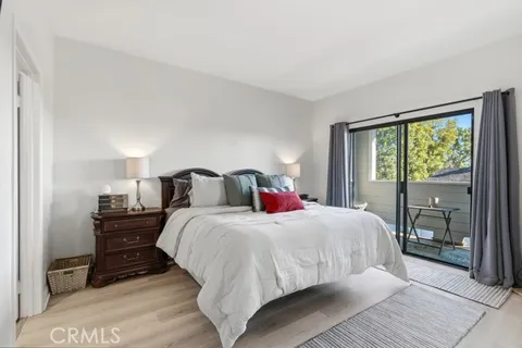 a bedroom with a bed and a large mirror