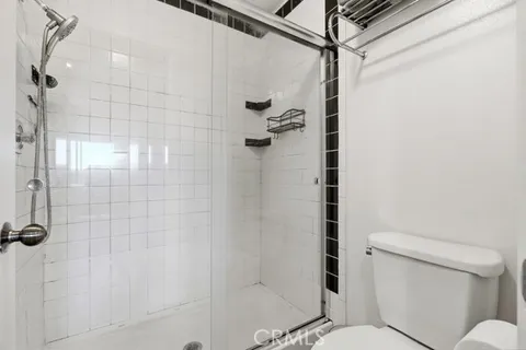 a bathroom with a sink vanity mirror and toilet