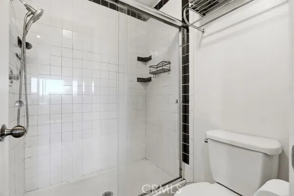 a bathroom with a sink vanity mirror and toilet