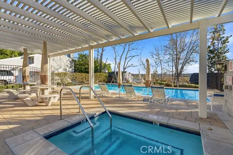 a view of a house with a yard and large trees