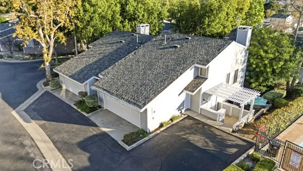 a view of a house with a yard and large tree