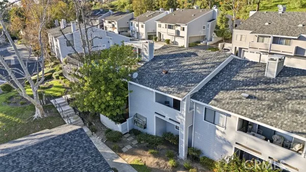 a aerial view of a house with large trees and plants