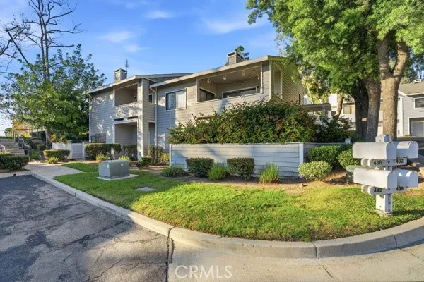 a view of a house with backyard and sitting area
