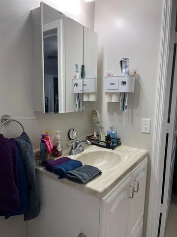 a kitchen with stainless steel appliances a sink and cabinets